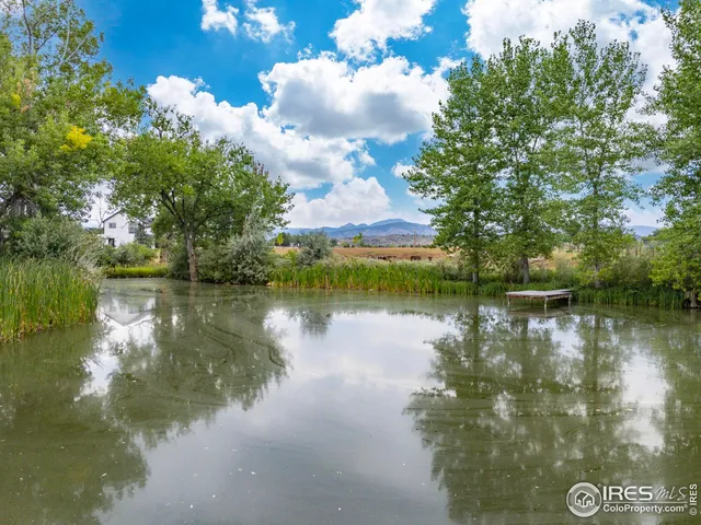 a view of a lake in between two and trees