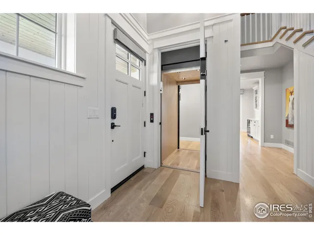 a view of an entryway with wooden floor