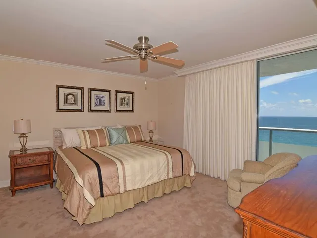 a bedroom with a bed and ceiling fan