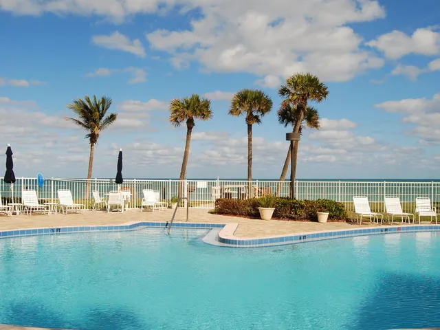a view of a lake with couches and ocean view