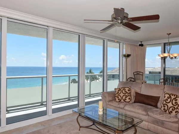 a living room with furniture and a floor to ceiling window