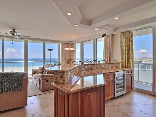 a large kitchen with kitchen island granite countertop a large window