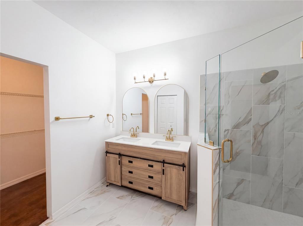 9405 Southwest 31st Lane Gainesville, FL 32608 - Photo 13 of 30 a bathroom with a double vanity sink mirror and