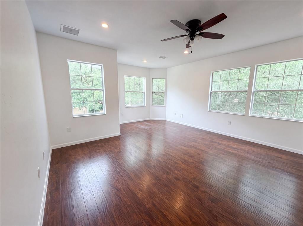 9405 Southwest 31st Lane Gainesville, FL 32608 - Photo 19 of 30 a view of an empty room with wooden floor and a window