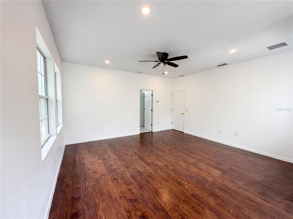 9405 Southwest 31st Lane Gainesville, FL 32608 - Photo 20 of 30 a view of empty room with wooden floor and fan