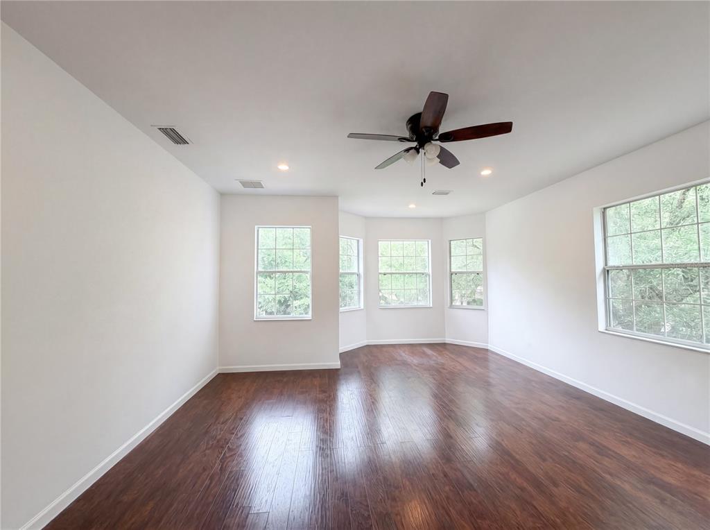 9405 Southwest 31st Lane Gainesville, FL 32608 - Photo 21 of 30 a view of an empty room with wooden floor and a window