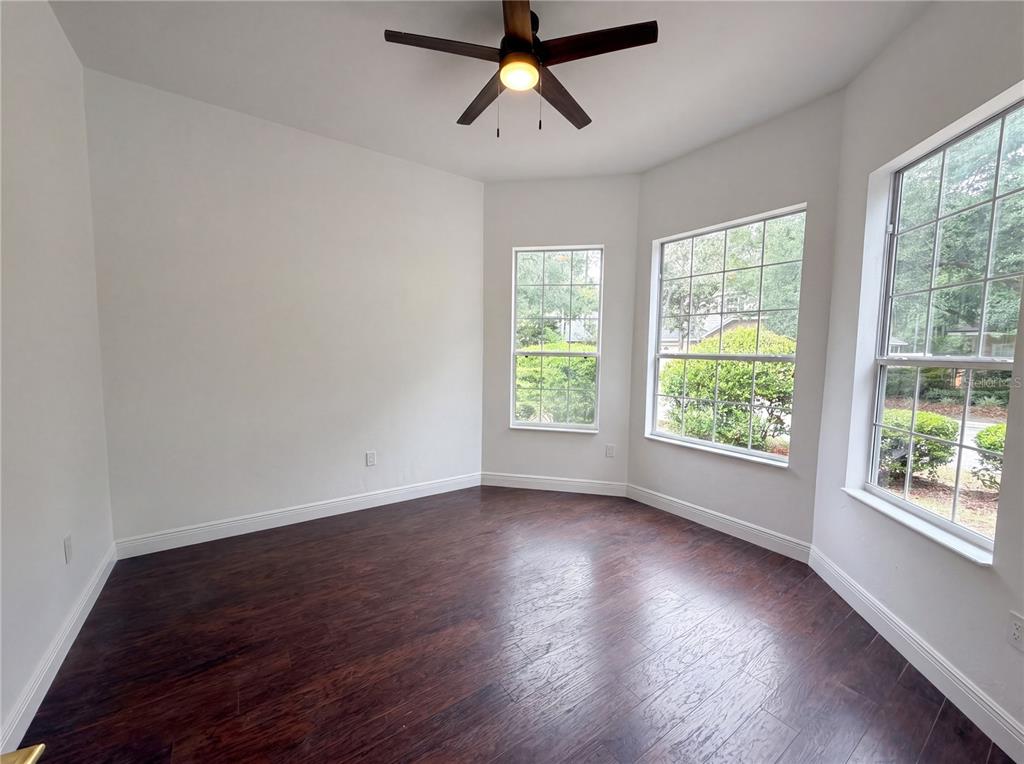 9405 Southwest 31st Lane Gainesville, FL 32608 - Photo 22 of 30 a view of room window and wooden floor