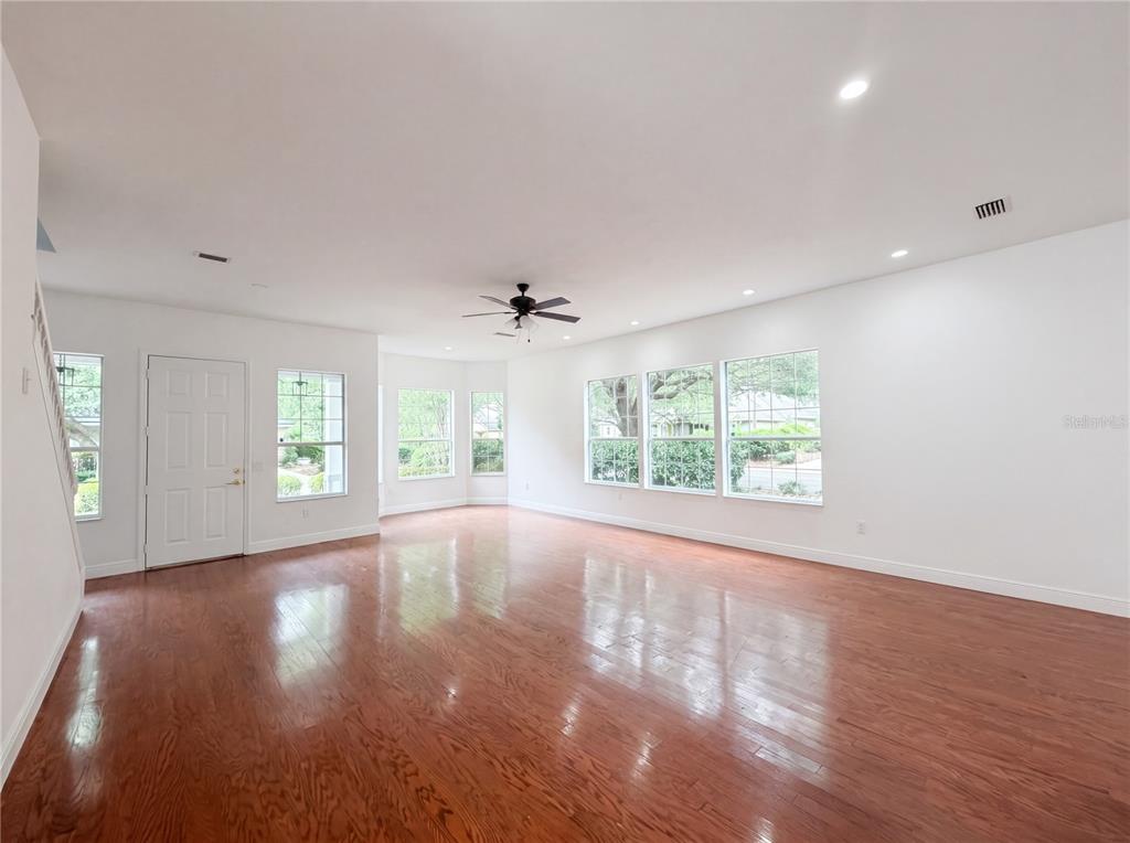 9405 Southwest 31st Lane Gainesville, FL 32608 - Photo 23 of 30 a view of an empty room with wooden floor and a window