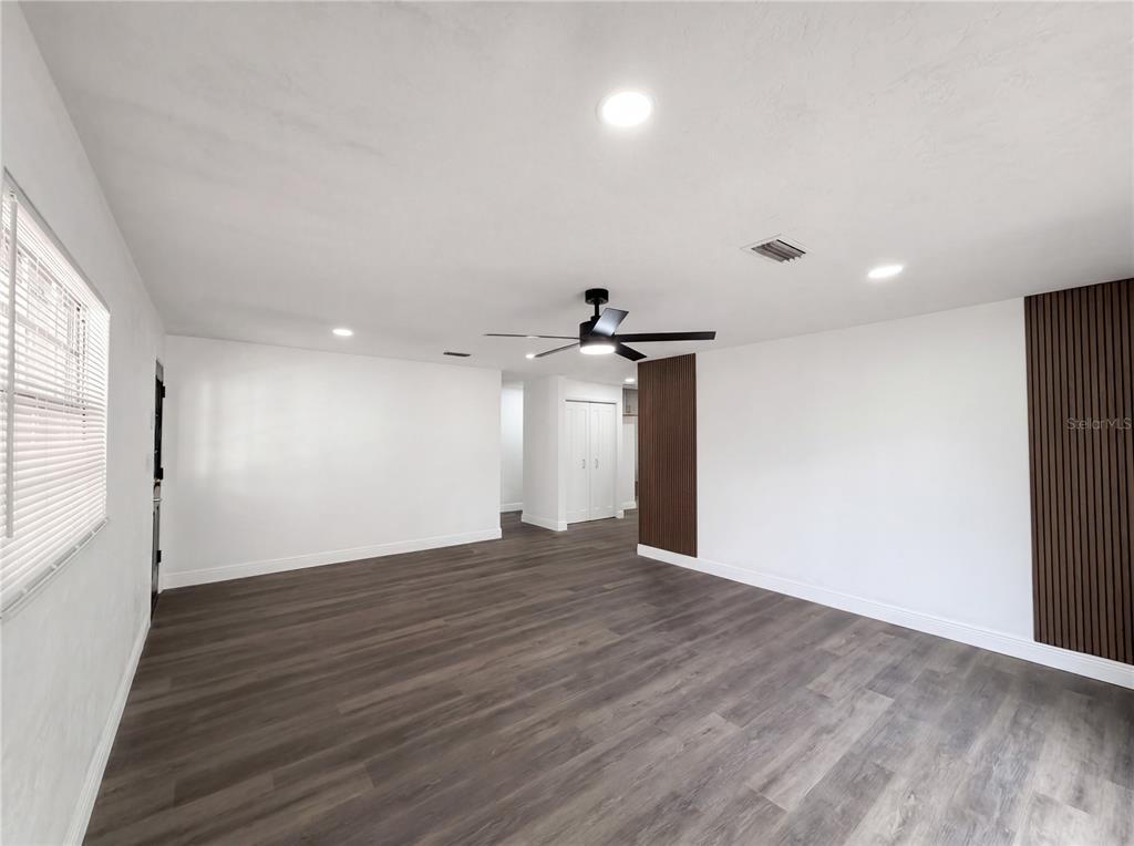 9405 Southwest 31st Lane Gainesville, FL 32608 - Photo 25 of 30 a view of an empty room with wooden floor and a window