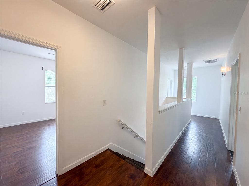 9405 Southwest 31st Lane Gainesville, FL 32608 - Photo 26 of 30 a view of a hallway with wooden floor