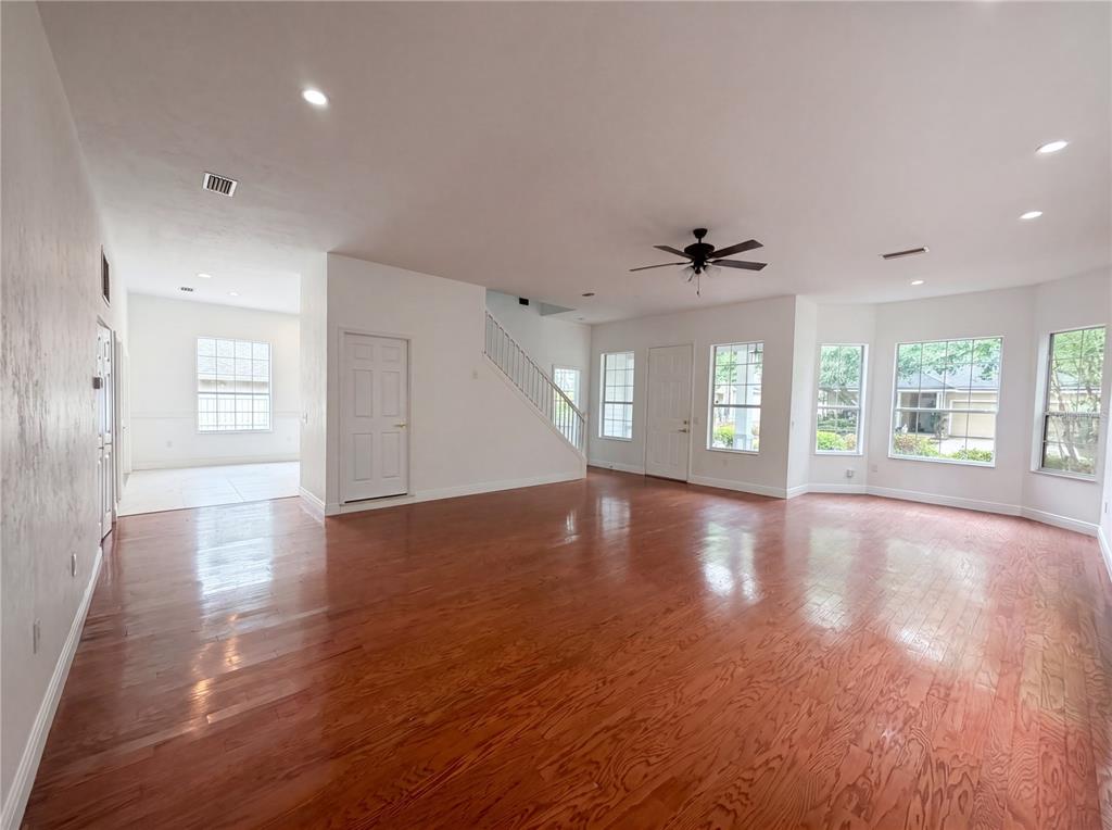 9405 Southwest 31st Lane Gainesville, FL 32608 - Photo 3 of 30 a view of an empty room with wooden floor and a window