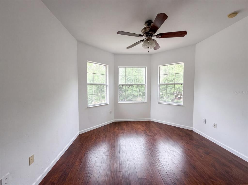 9405 Southwest 31st Lane Gainesville, FL 32608 - Photo 7 of 30 a view of an empty room with wooden floor and a window