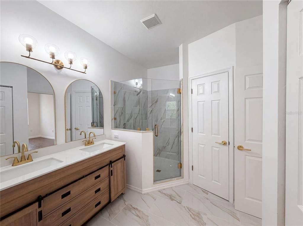 9405 Southwest 31st Lane Gainesville, FL 32608 - Photo 10 of 30 a spacious bathroom with a double vanity sink mirror and double