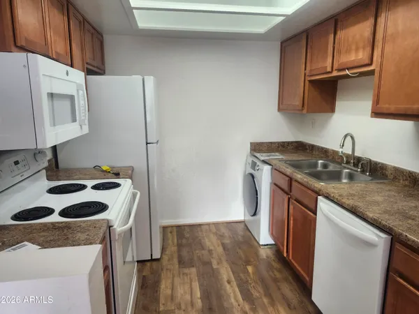 a kitchen with a sink a stove a refrigerator and cabinets