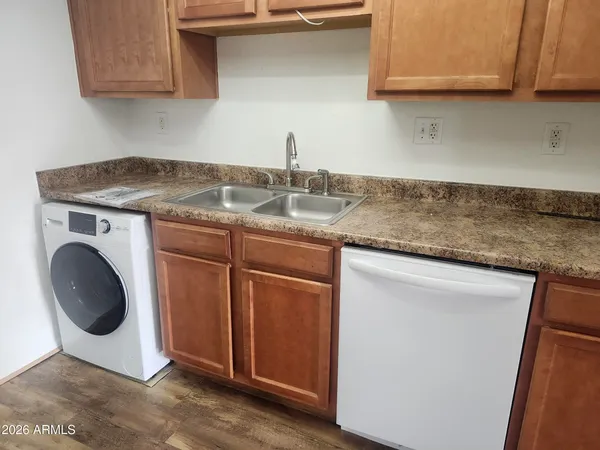 a kitchen with stainless steel appliances granite countertop a sink a stove and cabinets