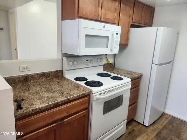 a white refrigerator freezer sitting inside of a kitchen