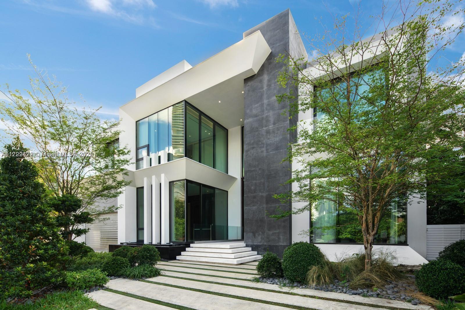 18530 North Bay Road Sunny Isles Beach, FL 33160 - Photo 1 of 10 a front view of a house with a garden