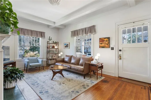 a living room with furniture and a potted plant