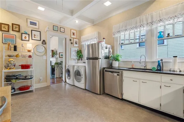 a spacious bedroom with a bed and a potted plant