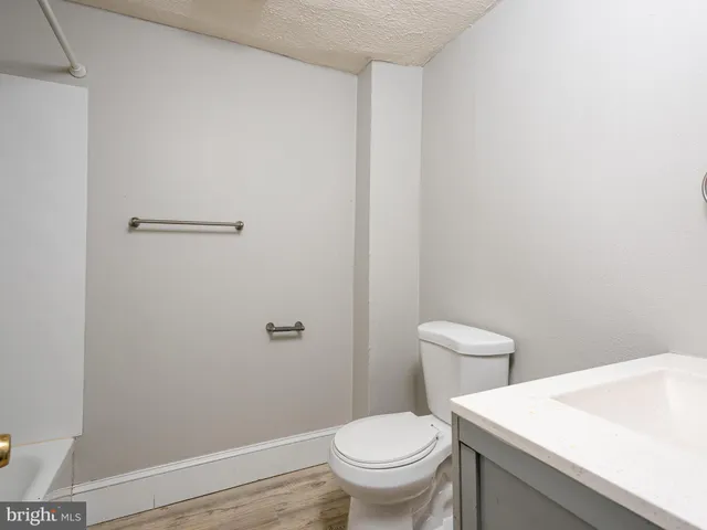 a white toilet sitting next to a bathroom sink