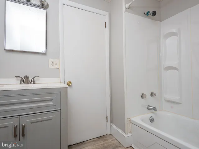 a bathroom with a bathtub and a sink