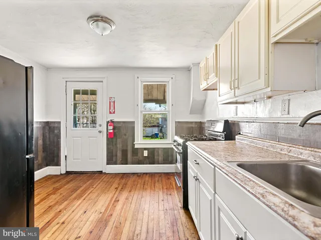 a kitchen with a sink and refrigerator