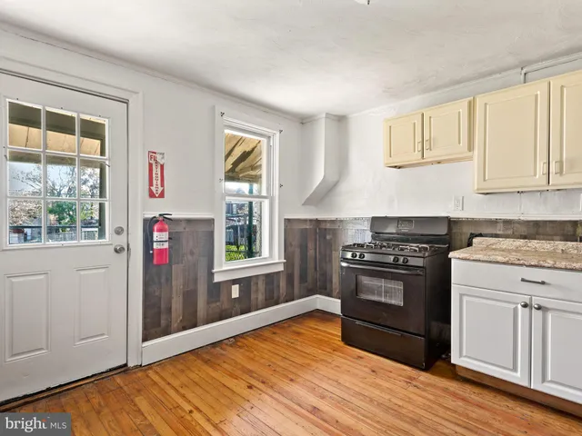 a kitchen with granite countertop a stove and a refrigerator