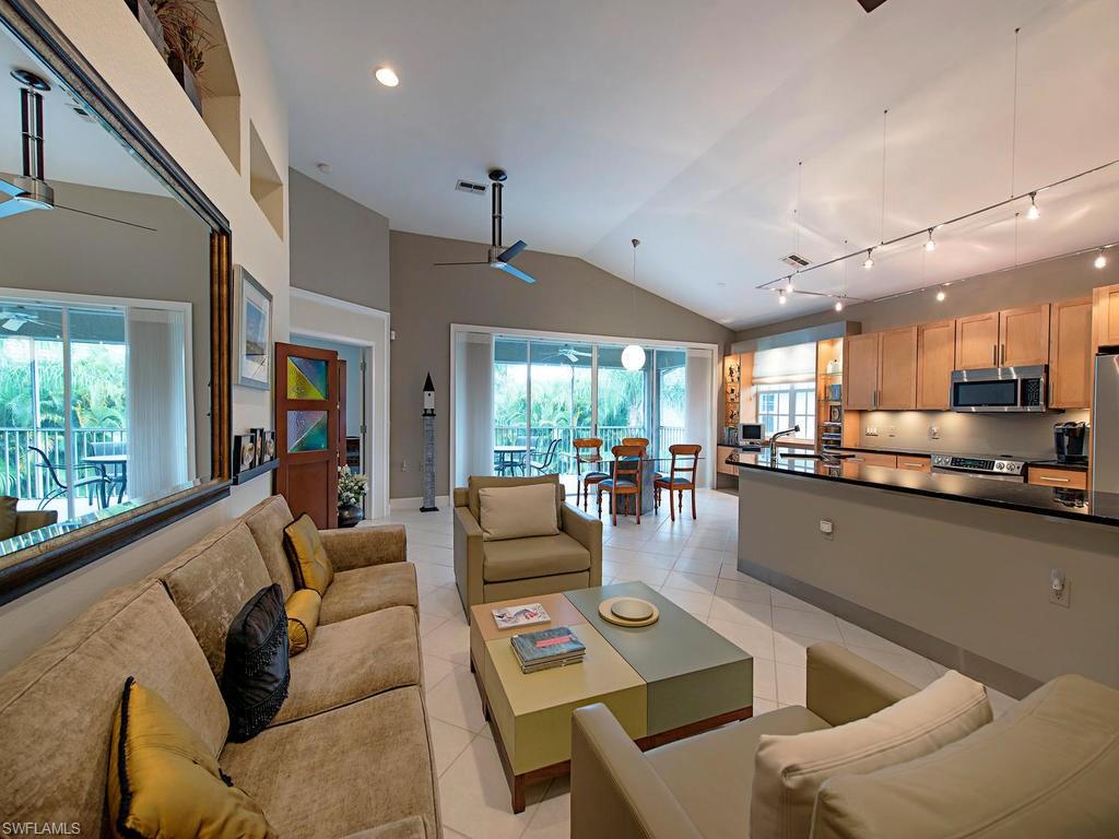7120 Timberland Circle, Unit 202 Naples, FL 34109 - Photo 1 of 12 a living room with furniture and a large window