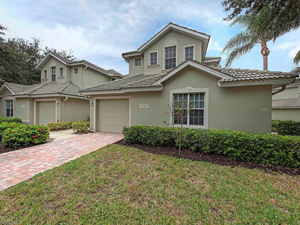 7120 Timberland Circle, Unit 202 Naples, FL 34109 - Photo 11 of 12 a front view of a house with garden