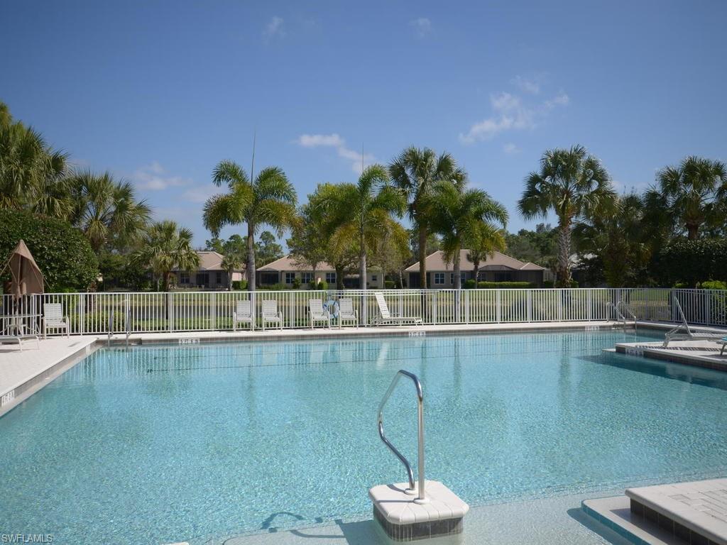 7120 Timberland Circle, Unit 202 Naples, FL 34109 - Photo 12 of 12 a view of a swimming pool with a table and chairs