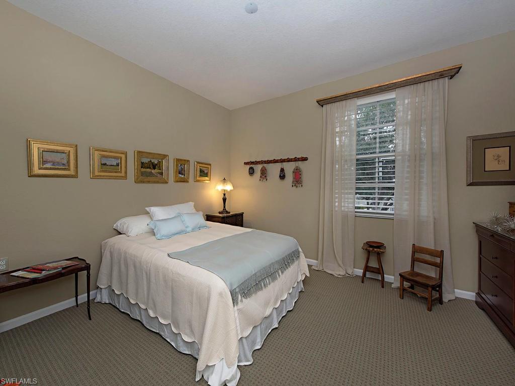7120 Timberland Circle, Unit 202 Naples, FL 34109 - Photo 8 of 12 a bedroom with a bed chair and a window