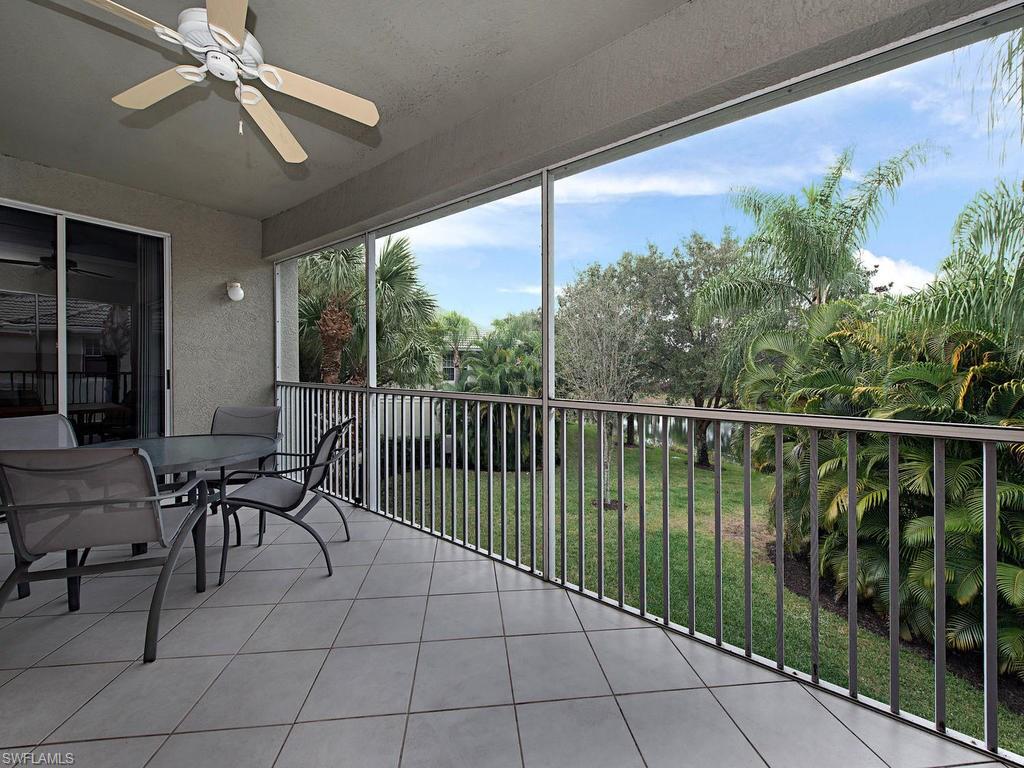 7120 Timberland Circle, Unit 202 Naples, FL 34109 - Photo 10 of 12 a balcony with table and chairs