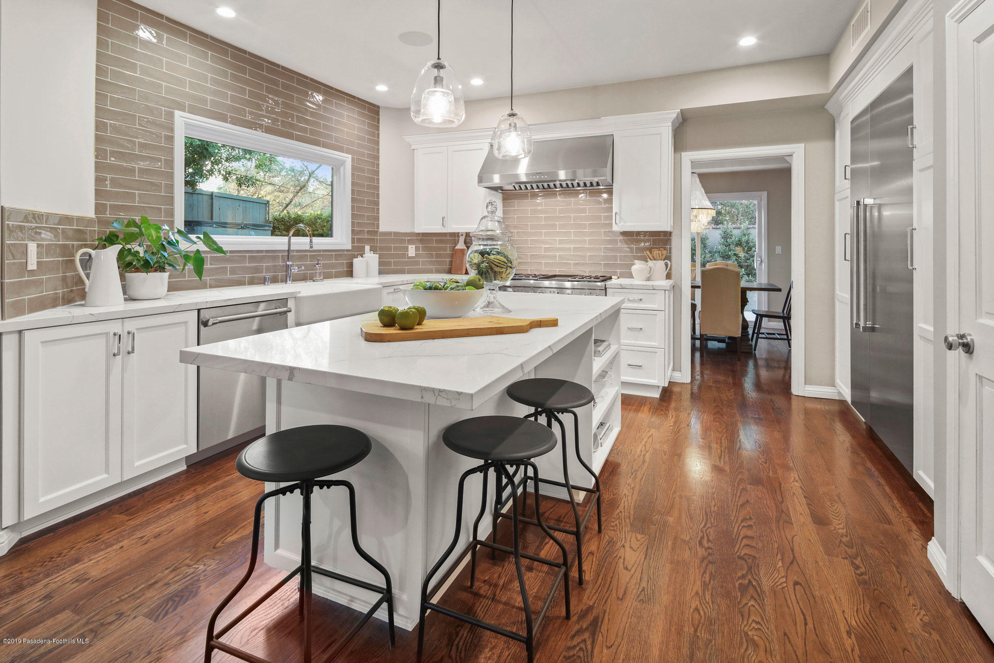 45 Club Road Pasadena, CA 91105 - Photo 11 of 36 a kitchen with stainless steel appliances a table and chairs in it