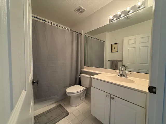 a view of a kitchen with a sink and a refrigerator