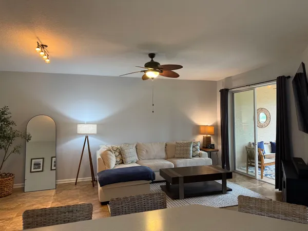 a living room with furniture and a floor to ceiling window