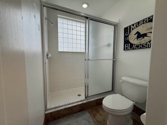 a living room with furniture a desk and a flat screen tv