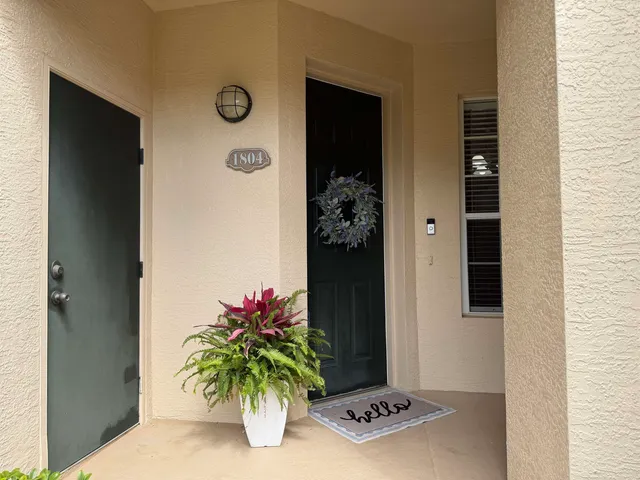 a blue sign that is next to a white house