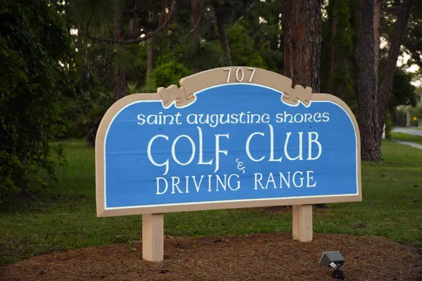 a living room with furniture and a lamp