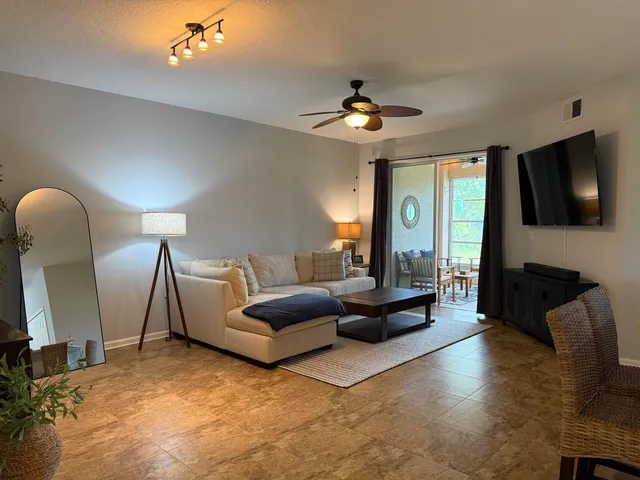 a living room with furniture a dining table and a fireplace