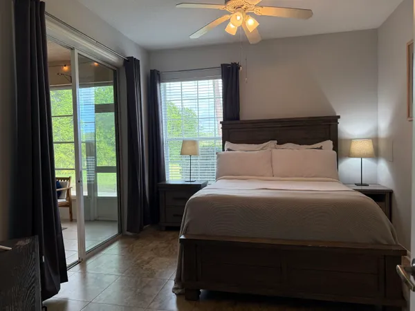 a bedroom with a bed and a flat tv screen on dresser