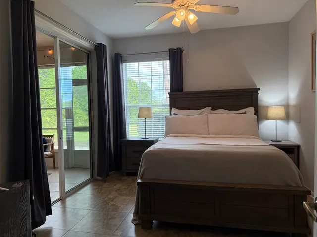 a bedroom with a bed and a flat tv screen on dresser