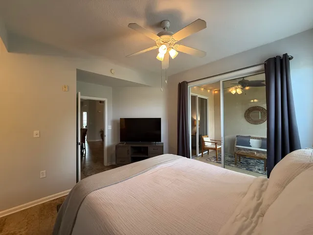 a spacious bathroom with a granite countertop sink a mirror and a bathtub
