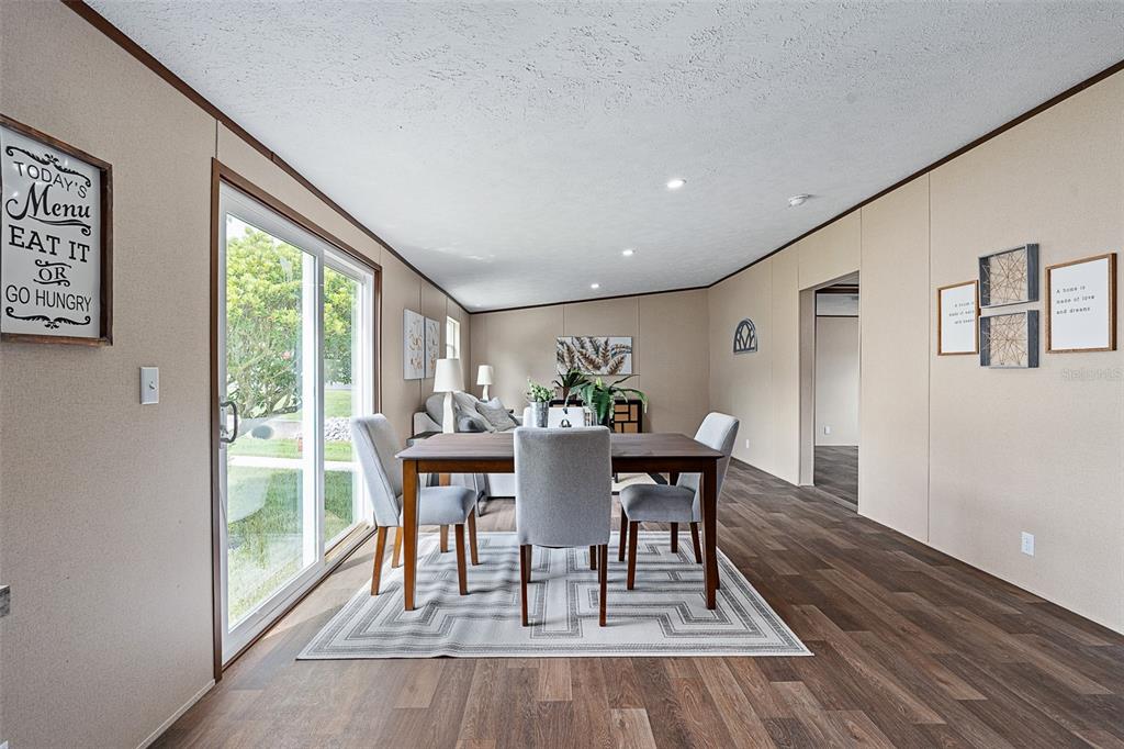 8150 Cherokee Road Bartow, FL 33830 - Photo 19 of 35 a view of a dining room with furniture window and wooden floor