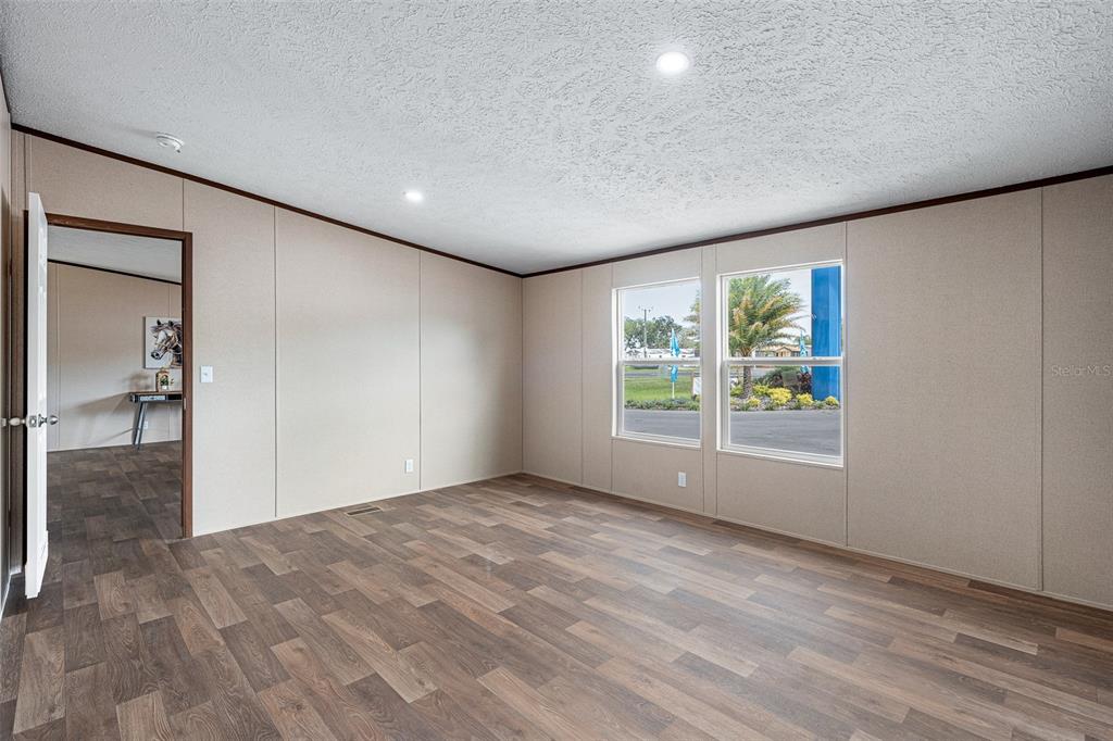 8150 Cherokee Road Bartow, FL 33830 - Photo 22 of 35 a view of empty room with wooden floor and fan
