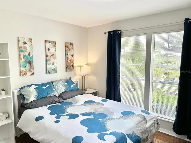 a bedroom with a large bed and a couch