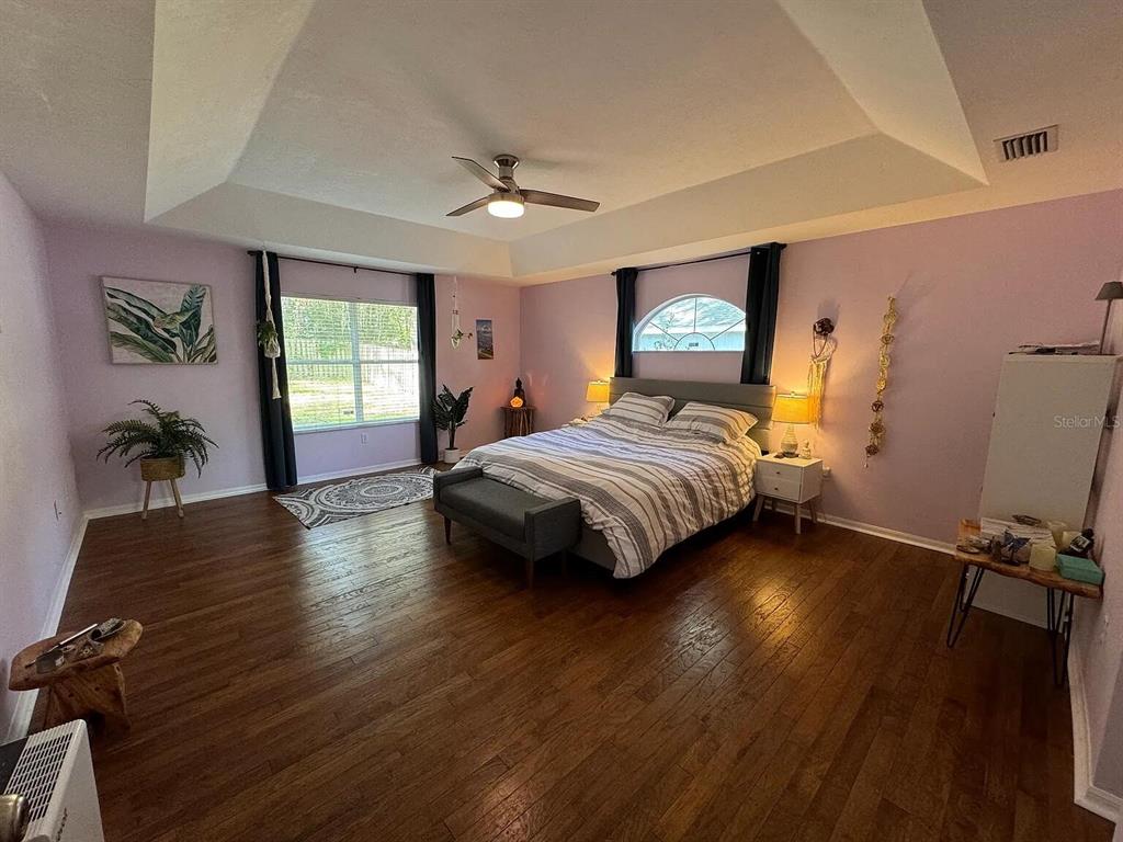 5164 Southwest 82 Terrace Gainesville, FL 32608 - Photo 2 of 25 a bedroom with a bed and wooden floor