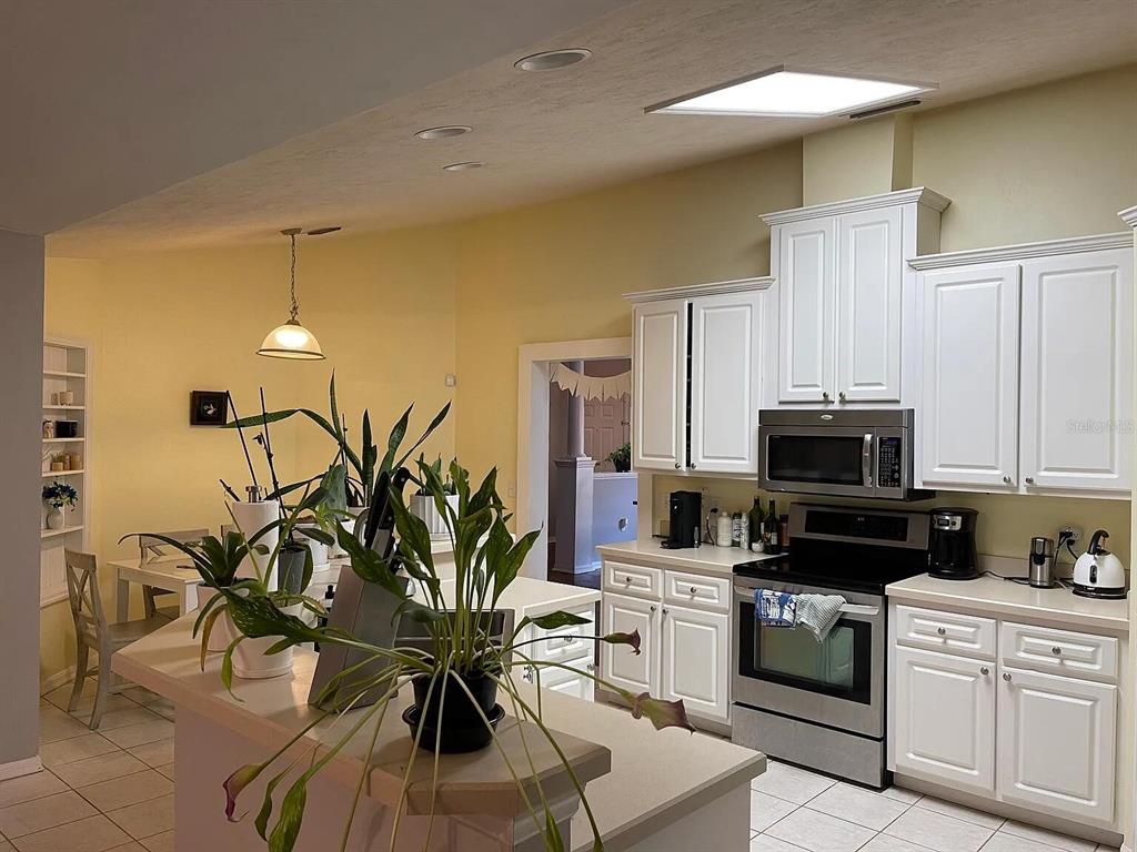 5164 Southwest 82 Terrace Gainesville, FL 32608 - Photo 23 of 25 a kitchen with granite countertop a stove and a white cabinets