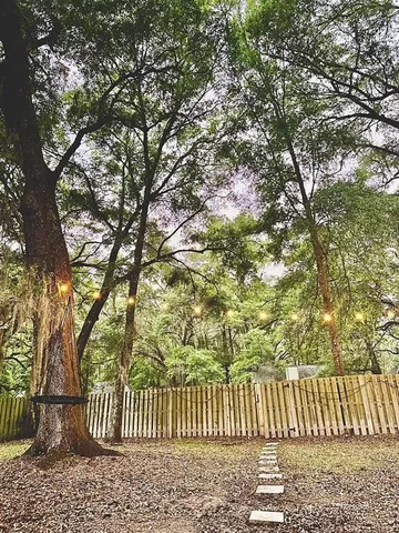 a view of a yard with wooden fence and floor