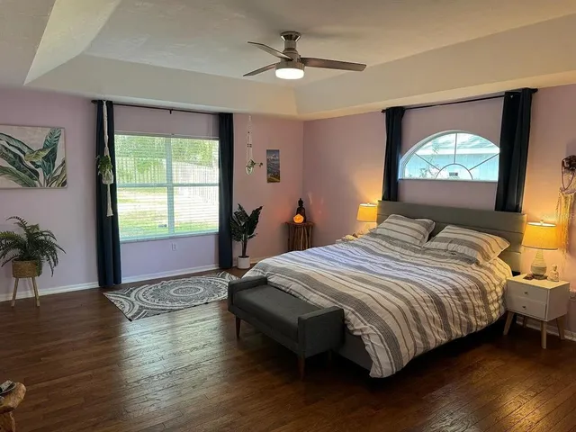 a bedroom with a bed and a flat screen tv