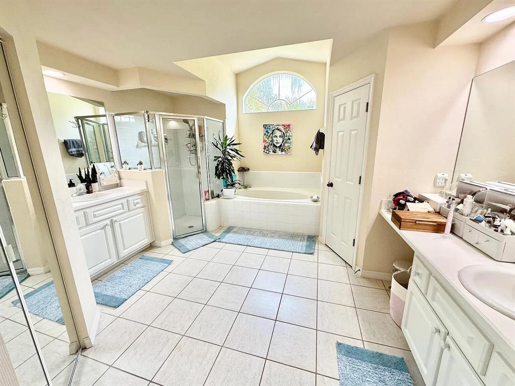 5164 Southwest 82 Terrace Gainesville, FL 32608 - Photo 5 of 25 a spacious bathroom with a sink a mirror a bathtub and next to a window